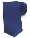 A handsome solid tie in soft silk offsets your dress shirting with a satiny hue for a classic statement.