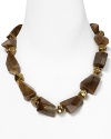 An on-trend blend of bold cut stones and small gold tone nuggets from RJ Graziano. This lustrous necklace is a workday to cocktails essential, just add heels.