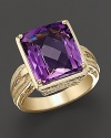 This beautiful ring is crafted from a large faceted amethyst in a square, 14 Kt. gold setting, with filigree detail along the band and cushion.