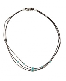 Earthy style with a hint of natural color. This simple three strand necklace by Fossil features turquoise resin and metal beads strung on dark natural leather cord. Brass tone mixed metal setting and button closure. Approximate length: 18 inches. Earthy style with a hint of natural color. This simple three strand necklace by Fossil features turquoise resin and metal beads strung on dark natural leather cord. Brass tone mixed metal setting and button closure. Approximate length: 18 inches.
