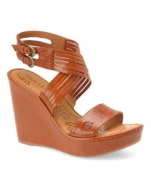 High and mighty. A daring wedge heel ensures you'll stand tall - and look chic - the Eleni platform sandals by Born. Crafted in leather, they feature unique crisscrossing straps and an adjustable double-buckle strap.