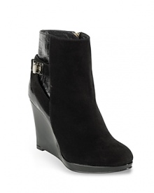 Cole Haan injects a high dose of fashion into abbreviated suede booties on patent wedges accented with embossed patent detailing and silver hardware. Cole Haan injects a high dose of fashion into abbreviated suede booties on patent wedges accented with embossed patent detailing and silver hardware.