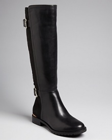 These Isaac Mizrahi New York boots feature stretch Lycra backs for the perfect, easy-on fit. Metal logo plates and shining buckles pull the look together; it's the ideal comfort-meets-style go-to. These Isaac Mizrahi New York boots feature stretch Lycra backs for the perfect, easy-on fit. Metal logo plates and shining buckles pull the look together; it's the ideal comfort-meets-style go-to.