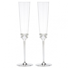 Romantics, take heart! Sweet-as-can-be bows accent these aptly-named champagne flutes. Romantics, take heart! Sweet-as-can-be bows accent these aptly-named champagne flutes.