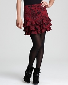 A rich hue and ruffled hem enliven an animal-print DKNY skirt, layered over sheer tights for a roaring fashion statement. A rich hue and ruffled hem enliven an animal-print DKNY skirt, layered over sheer tights for a roaring fashion statement.