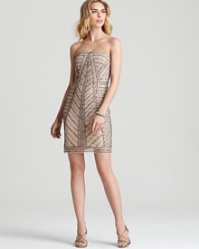 Adrianna Papell embraces natural beauty with a simple, strapless silhouette in a neutral hue. Adrianna Papell embraces natural beauty with a simple, strapless silhouette in a neutral hue.