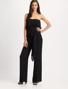 The contemporary jumpsuit gets a feminine touch in a filmy silk georgette flounceStraplessFlounce drapes from bodice to lower backSelf-beltWide legsInseam, about 44SilkDry cleanImported The contemporary jumpsuit gets a feminine touch in a filmy silk georgette flounceStraplessFlounce drapes from bodice to lower backSelf-beltWide legsInseam, about 44SilkDry cleanImported