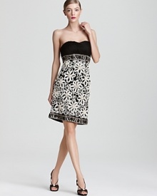 An intricately pleated bodice tops off a richly embellished skirt on this Sue Wong strapless dress. An intricately pleated bodice tops off a richly embellished skirt on this Sue Wong strapless dress.