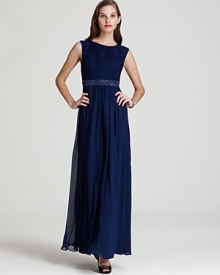 This finely pleated Aidan Mattox gown is accentuated with a dazzling beaded waistband for optimum glamour. This finely pleated Aidan Mattox gown is accentuated with a dazzling beaded waistband for optimum glamour.