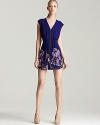 An exposed zip toughens up this richly hued GUESS dress, finished with a floral-print at the skirt for feminine flair.