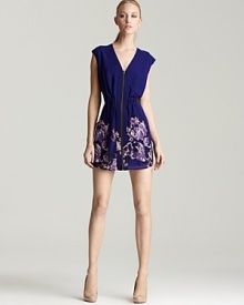 An exposed zip toughens up this richly hued GUESS dress, finished with a floral-print at the skirt for feminine flair. An exposed zip toughens up this richly hued GUESS dress, finished with a floral-print at the skirt for feminine flair.