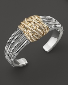 Diamonds in 18K yellow gold wrap around this sterling silver statement cuff from Lagos. Diamonds in 18K yellow gold wrap around this sterling silver statement cuff from Lagos.