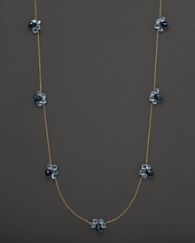 Seven blue topaz stations, set in 14K yellow gold.