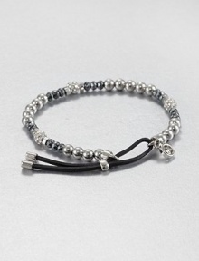 From the Brilliance Collection. A mix of silvery beads includes faceted hematite, smooth stainless steel and rhinestone-crusted spheres, strung on a stretchy strand with a leather slide close.HematiteGlassSilvertone and stainless steelLeatherDiameter, about 2.25Imported