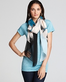Cream flowers pop against the blue-to-black ombre background of this DIANE von FURSTENBERG scarf. Cream flowers pop against the blue-to-black ombre background of this DIANE von FURSTENBERG scarf.