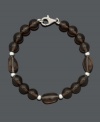 Slip into neutral style for a subtle finishing touch. This chic bracelet features 8 to 9 mm smokey quartz beads (75 ct. t.w.) with sterling silver accents and setting. Approximate length: 7-1/2 inches.