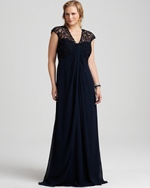 Feel utterly glamorous in this flowing gown from Tadashi Shoji Plus. Features a mesmerizing cage-like overlay made from fine embroidery over mesh. Feel utterly glamorous in this flowing gown from Tadashi Shoji Plus. Features a mesmerizing cage-like overlay made from fine embroidery over mesh.