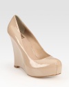 Inimitable patent leather essential modernized by a sculpted wedge and hidden platform. Self-covered wedge, 4½ (115mm)Hidden platform, 1 (25mm)Compares to a 3½ heel (90mm)Patent leather upperLeather lining and solePadded insoleImported