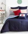 This Midnight Hilfiger Prep decorative pillow features a patriotic blue landscape with red accents. The unique combination of allover diamond quilting and signature ribbon elements reflect classic Tommy Hilfiger style.