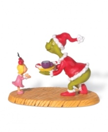 A scene right out of the Dr. Seuss classic! The devious Grinch, posing as Santa Claus, charms little Cindy Lou Who with a midnight snack when he's caught trying to steal Christmas!