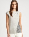 A tee with some twists, this sleeveless style is shaped with tiny pleats at one shoulder and lace trim and overlays for an edgy appeal.Round banded neckline with lace trim on one sideSleeveless on one side, cap sleeve with lace trim on the otherPleats at one shoulderAsymmetrical flange and lace overlay on one sideAbout 26 from shoulder to hemCotton/modalDry cleanImported of Italian fabricSIZE & FITModel shown is 5'10 (177cm) wearing US size Small. 
