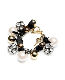Add a little funk to the traditional charm bracelet and you've got another innovative design by Betsey Johnson. Glam it up with sparkling fireballs, shiny beads, crystal-accented rosebuds, acrylic pearls, and a key charm all strung together by a black ribbon and toggle clasp. Crafted in antique gold and silver tone mixed metal. Approximate length: 7 inches.