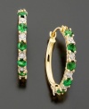 Round-cut emeralds (5/8 ct. t.w.) and diamond accents punch up 14k gold hoops. Diameter measures approximately 3/4 inch.