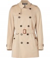 With heritage detailing reflecting the original Burberry trench coat, this mid-length cotton gabardine version from Burberry London counts as an iconic, multi-season investment - Classic collar with belted latch and hook closure, set-in long sleeves with belted cuffs, epaulettes, gun flap, double-breasted button-down front, belted waist, rain shield - Fitted silhouette - Pair with slim trousers or jeans and a cashmere pullover