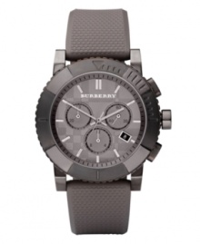 This Burberry timepiece features a trench rubber strap and round gray ion-plated stainless steel case. Trench checked dial features silver tone stick indices, date window at four o'clock, three subdials, three hands and logo. Quartz movement. Water resistant to 100 meters. Two-year limited warranty. This Burberry timepiece features a trench rubber strap and round gray ion-plated stainless steel case. Trench checked dial features silver tone stick indices, date window at four o'clock, three subdials, three hands and logo. Quartz movement. Water resistant to 100 meters. Two-year limited warranty.