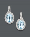 Polish your look with the perfect pair. These elegant oval drop earrings feature a oval-cut blue topaz (3-1/10 ct. t.w.) surrounded by glittering diamond accents. Set in sterling silver. Approximate drop: 3/4 inch.