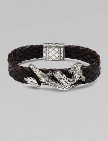 An intricately detailed sterling silver dragon wraps itself around a band of braided leather.SilverBraided leatherPush-lock claspAbout 8½ longAbout ¾ wideImported