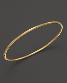 Stunningly simple, Roberto Coin's 18K gold satin bangle makes a subtle statement in a satin finish. Stunningly simple, Roberto Coin's 18K gold satin bangle makes a subtle statement in a satin finish.