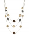 This lengthy layered necklace from Kenneth Cole New York showcases hematite and gold tone wire-wrapped beads and bronze faceted fireball beads. Crafted in gold tone and hematite tone mixed metal. Approximate length: 17 inches + 3-inch extender. Approximate drop: 3 inches.