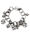 Versatile style. Whether you wear it for daytime or evening, AK Anne Klein's link bracelet will add a dressy dimension to your look. Crafted in hematite tone mixed metal with a toggle closure, it's adorned by glittering glass accents and gray acrylic pearls. Approximate length: 7-1/2 inches.