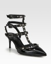 Strong point toe silhouette of patent leather with signature metal studs on adjustable leather straps. Self-covered heel, 2¾ (70mm)Patent leather upper with metal studded leather trimPoint toeThree adjustable ankle strapsLeather lining and solePadded insoleMade in Italy