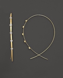 Diamond dot Lana's slim, elegant 14K yellow gold hoop earrings. Diamond dot Lana's slim, elegant 14K yellow gold hoop earrings.