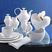 Organic shaped dinnerware created exclusively with Royal Stafford for Bloomingdales by the legendary 101-year old designer Eva Zeisel. Clean, sculptural lines and neutral colors are her signature. This collection of dinnerware and serving pieces capture the essence of her world-renowned style. Shown clockwise from the top middle: Teapot, Rockland Bowl, Gravy Boat, S&P Shakers, Dinner Plate, Salad Plate, Cup and Saucer (stacked), Sugar and Creamer.