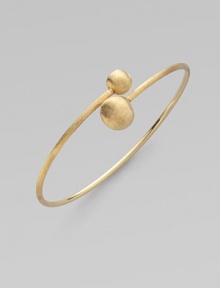 From the Africa Collection. Two textured orbs cross paths along a thin 18k yellow gold band.18k yellow gold Diameter, about 7 Made in Italy From the Africa Collection. Two textured orbs cross paths along a thin 18k yellow gold band.18k yellow gold Diameter, about 7 Made in Italy