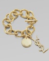 Shiny YSL logo charms dangle from bold, textured goldtone links. Toggle closure About 9 long Made in Italy