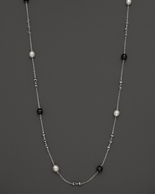 This sterling silver necklace, gleaming with blue tigers eye and freshwater pearls, makes an elegant statement. By Di MODOLO. This sterling silver necklace, gleaming with blue tigers eye and freshwater pearls, makes an elegant statement. By Di MODOLO.