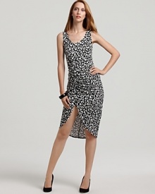 A high-contrast print of leopard spots in black and white, alluring ruching, and a dramatic side slit add up to a powerful presence in this Karen Kane dress. A high-contrast print of leopard spots in black and white, alluring ruching, and a dramatic side slit add up to a powerful presence in this Karen Kane dress.