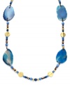 Elemental style. Lauren by Ralph Lauren's expedition necklace features semi-precious blue agate slices strung together with metal discs and glass beads. Set in brass tone mixed metal with a toggle clasp closure. Approximate length: 36 inches.