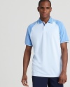 An athletic polo enhances your look with an on-trend color-block design from Zero Restriction.