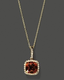 Diamonds frame a faceted citrine, set in 14K yellow gold. Diamonds frame a faceted citrine, set in 14K yellow gold.