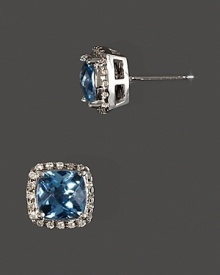 Diamonds frame faceted blue topaz, set in 14K yellow gold. Diamonds frame faceted blue topaz, set in 14K yellow gold.