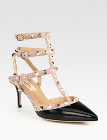Studded t-strap design of patent leather and calfskin in a contrasting tone, finished with a timeless point toe. Patent leather-covered heel, 2½ (65mm)Patent leather and leather upper with metal studsPoint toeAdjustable ankle strapsLeather lining and solePadded insoleMade in Italy Studded t-strap design of patent leather and calfskin in a contrasting tone, finished with a timeless point toe. Patent leather-covered heel, 2½ (65mm)Patent leather and leather upper with metal studsPoint toeAdjustable ankle strapsLeather lining and solePadded insoleMade in Italy