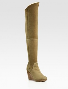 Thigh-high suede wedge design with an exposed back zipper and contoured shaft. Stacked wedge, 4 (100mm)Covered platform, ½(15mm)Compares to a 3½ heel (90mm)Shaft, 24Leg circumference, 15Suede upperBack zipperShearling liningRubber solePadded insoleMade in Italy Thigh-high suede wedge design with an exposed back zipper and contoured shaft. Stacked wedge, 4 (100mm)Covered platform, ½(15mm)Compares to a 3½ heel (90mm)Shaft, 24Leg circumference, 15Suede upperBack zipperShearling liningRubber solePadded insoleMade in Italy