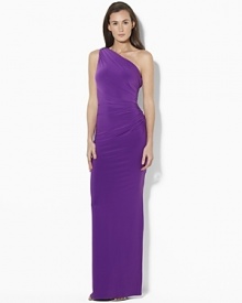 The sweeping glamour of a one-shoulder silhouette is captured in the elegant matte jersey dress, embellished with delicate ruching and a dazzling crystal-encrusted accent. The sweeping glamour of a one-shoulder silhouette is captured in the elegant matte jersey dress, embellished with delicate ruching and a dazzling crystal-encrusted accent.