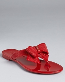 A dramatic, textured bow rests at the front of a dressed-up flip flop sandal from Salvatore Ferragamo. A dramatic, textured bow rests at the front of a dressed-up flip flop sandal from Salvatore Ferragamo.