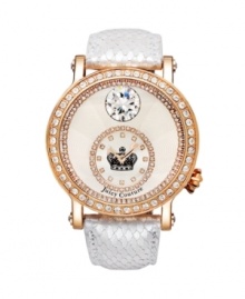Golden touches of rose and sparkles galore. Queen Couture watch by Juicy Couture crafted of white snake-embossed leather strap and round rose-gold-plated stainless steel case. Bezel crystallized with Swarovski elements. Textured silver tone dial features ring of crystals at outer edge, large crystal at twelve o'clock and a crystal-accented subdial at six o'clock with crown logo at center and two rose-gold tone hands. Quartz movement. Water resistant to 30 meters. Two-year limited warranty.